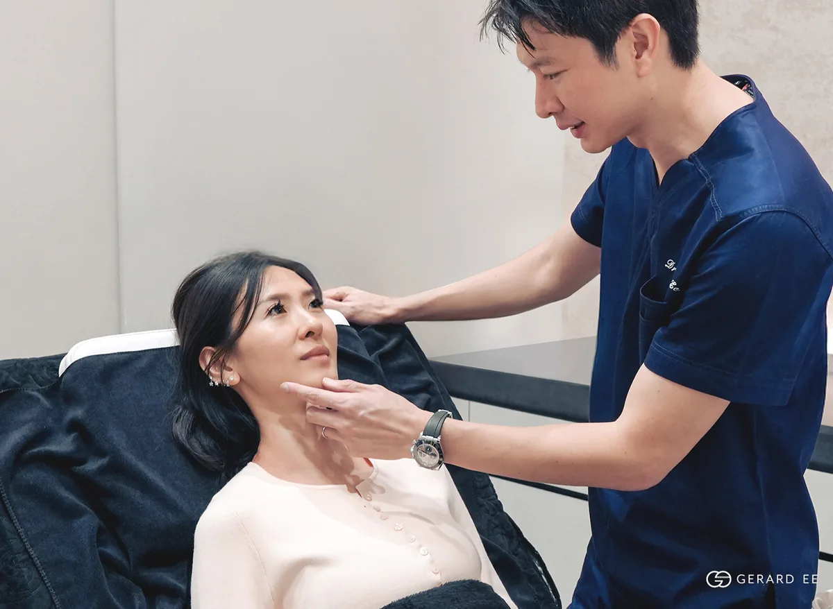 Dr Gerard Ee examining a patient to tell an eye bag from a tear trough